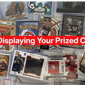 May include: A collection of sports trading cards and a Pokemon card, encased in protective sleeves. A red banner across the image reads "It's 2026... Stop Displaying Your Prized Cards in Boring 2D."