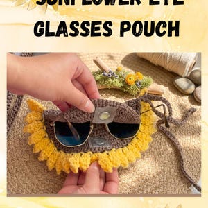 May include: Crocheted sunflower eye glasses pouch. The pouch is brown with a yellow sunflower design around the edges. The text "CRUCHET SUNFLOWER EYE GLASSES POUCH" is at the top of the image. The pouch is holding a pair of sunglasses.