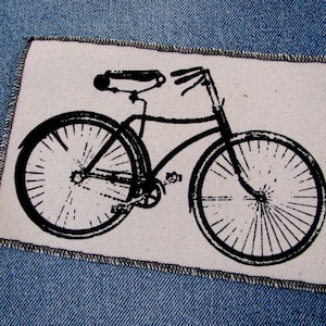 May include: Black and white illustration of a bicycle on a white background. The bicycle has a curved handlebar, a seat, two wheels, and a chain.