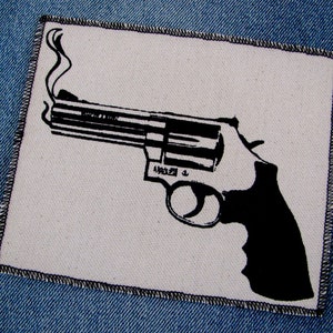 May include: A black and white illustration of a smoking revolver on a white background. The revolver is a classic design with a long barrel and a large cylinder.