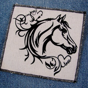 May include: Black and white embroidered patch of a horse's head with floral designs and the word "love" in a heart.