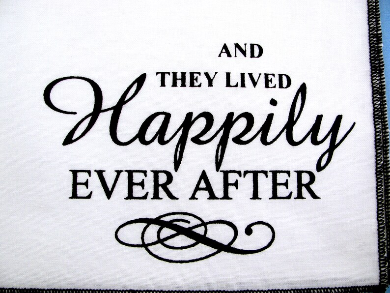 May include: White fabric with black text that reads "And they lived happily ever after" with a decorative flourish below the text.