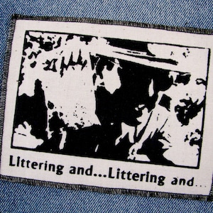 May include: Black and white patch with a graphic image of two people and the text "Littering and...Littering and..."