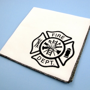 May include: White cotton tea towel with a black firefighter emblem that says "FIRE DEPT."