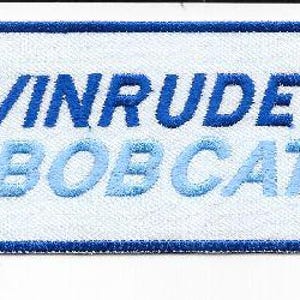 May include: Embroidered patch with the text "EVINRUDE BOB CAT" in blue and light blue, with a red accent on the "E". The patch is rectangular with a white background and a blue border.