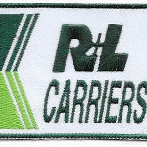 May include: Embroidered patch with the text "RL CARRIERS" in dark green on a white background. The patch has a rectangular shape with green and white accents and a green border. The patch is likely for a uniform or apparel.
