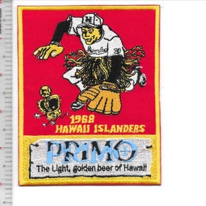May include: Embroidered patch featuring a baseball player in a white uniform with the text "Hawaii Islanders 1968." The patch has a red background with yellow borders and includes the "PRIMO" beer logo and the text "The Light, golden beer of Hawaii."