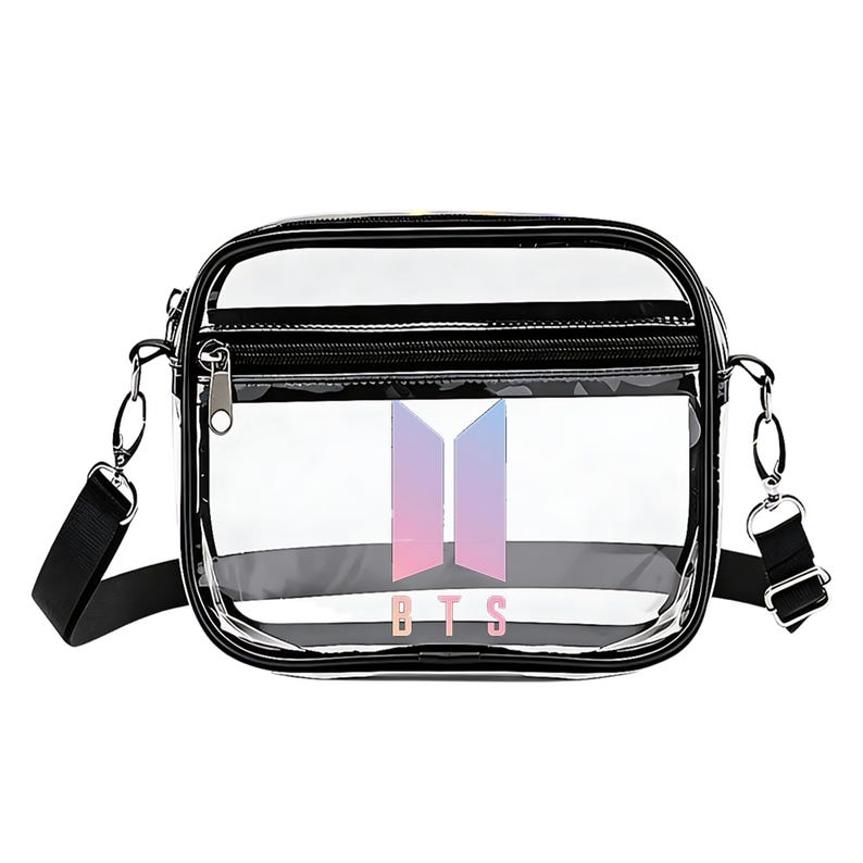 May include: Clear crossbody bag with a black trim and a black adjustable strap. The bag features a front zippered pocket and a BTS logo in shades of pink, purple, and blue.