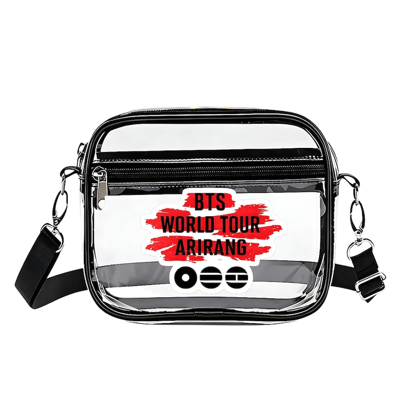 May include: Clear crossbody bag with black trim and a black adjustable strap. The bag features a front pocket with a zipper and a graphic that reads "BTS WORLD TOUR ARIRANG" in red and white.