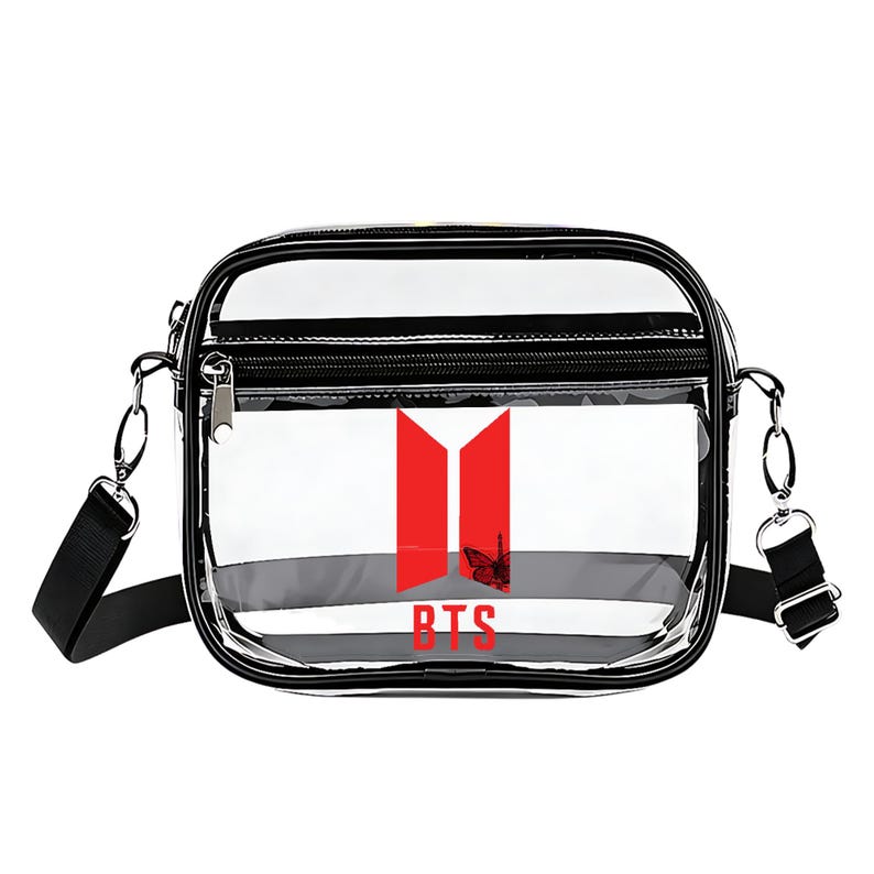 May include: Clear crossbody bag with a black trim and strap. The bag features a red and white graphic with the letters "BTS" in red. The bag has a zippered top and a silver-tone metal clasp.