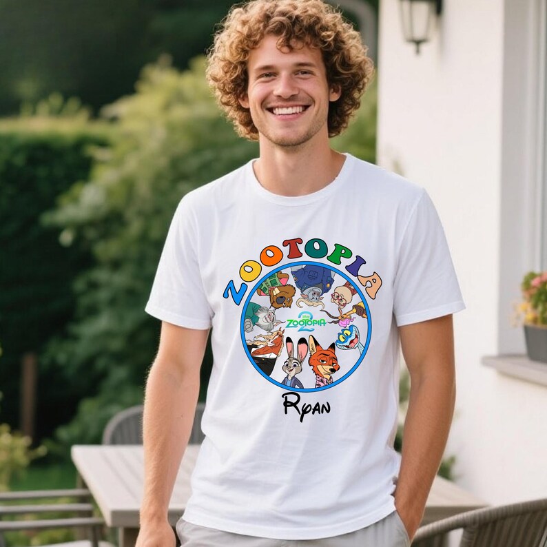 May include: White t-shirt featuring the word "ZOOTOPIA" in colorful letters above a circular graphic of characters from the animated movie. The name "Ryan" is printed below the graphic.
