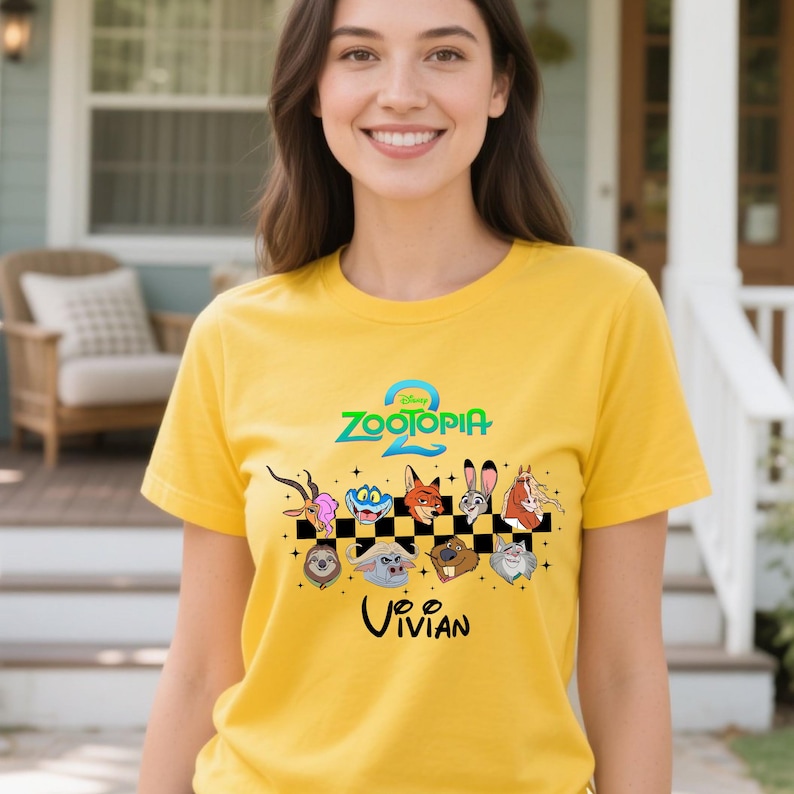 May include: Yellow short-sleeved t-shirt featuring the text "Zootopia 2" and various cartoon animal characters. The name "Vivian" is printed below the characters. The shirt is made of a soft material.