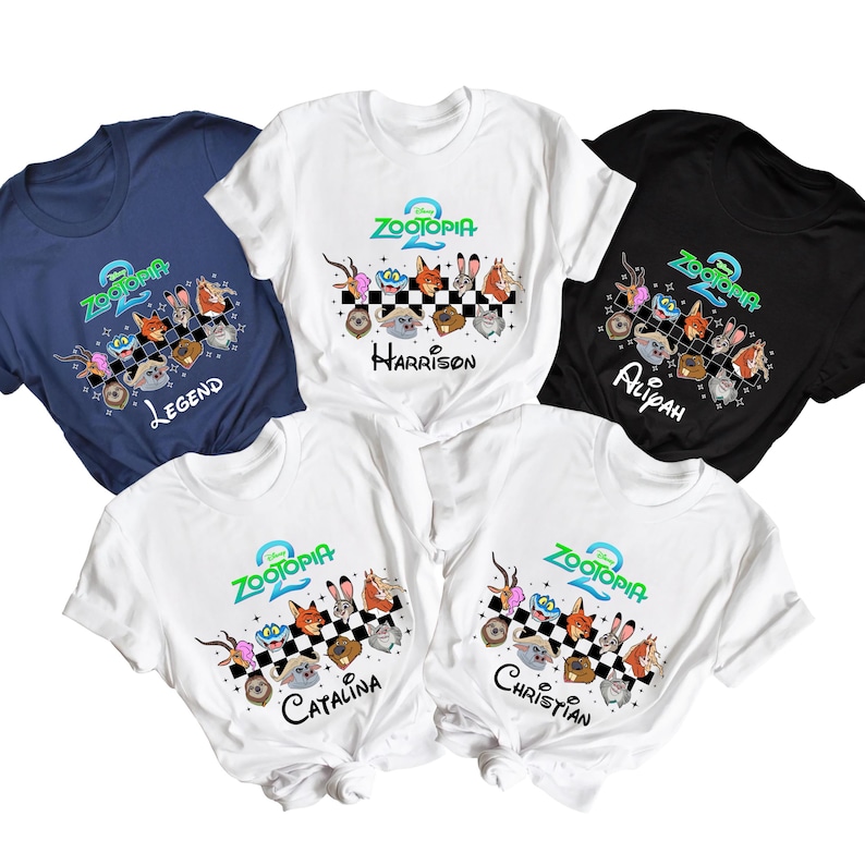 May include: Five short-sleeved t-shirts featuring the "Zootopia 2" logo and character illustrations. The shirts are navy blue, white, and black. Each shirt has a name printed below the graphic: Legend, Harrison, Alipah, Catalina, and Christian.