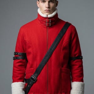 May include: A bright red jacket featuring a high collar with white faux shearling lining, two front buckle straps at the neck, and matching white shearling cuffs. The jacket includes black leather-like arm straps and a black diagonal shoulder strap.