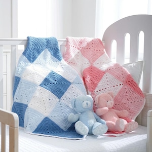 May include: Two crocheted baby blankets in a crib. One is blue and white, the other is pink and white. Two teddy bears, one blue and one pink, are on the bed. The blankets have a diamond pattern.