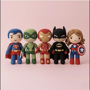May include: Five handmade crochet superhero dolls. Superman in blue and red, a green masked hero, Iron Man in red and gold, Batman in black, and Captain America in blue, red, and white with a shield. Each doll is approximately 6 inches tall.