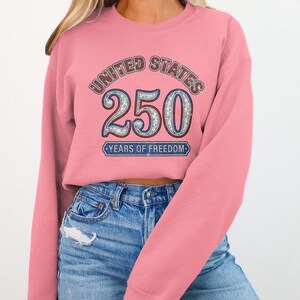 Pink sweatshirt with "United States 250 Years of Freedom" design.
