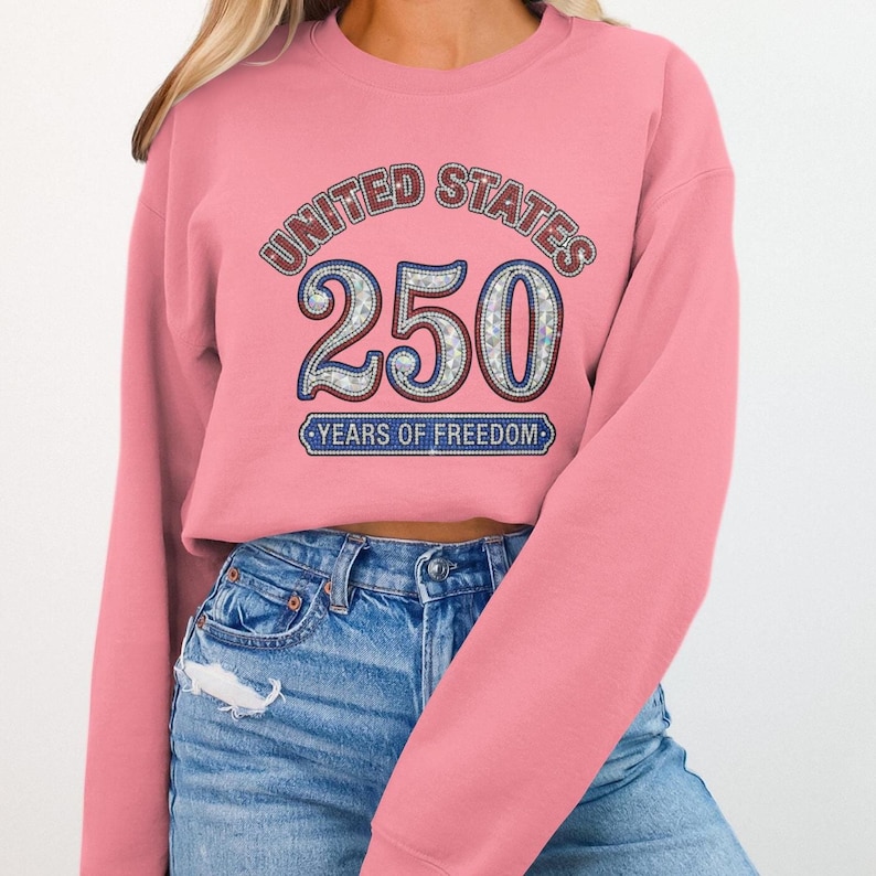 Pink sweatshirt with "United States 250 Years of Freedom" design.