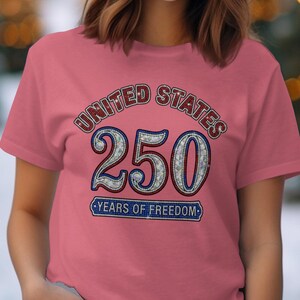 Pink t-shirt with "UNITED STATES 250 YEARS OF FREEDOM" design.