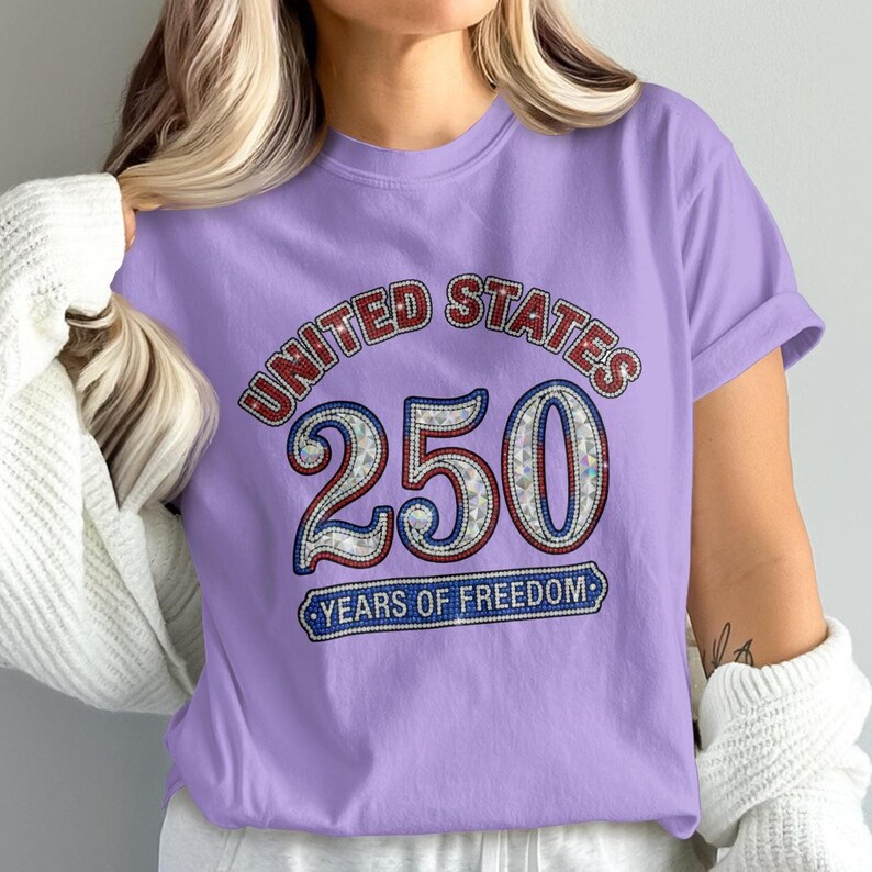 Purple t-shirt with "United States 250 Years of Freedom" text and sparkly accents.