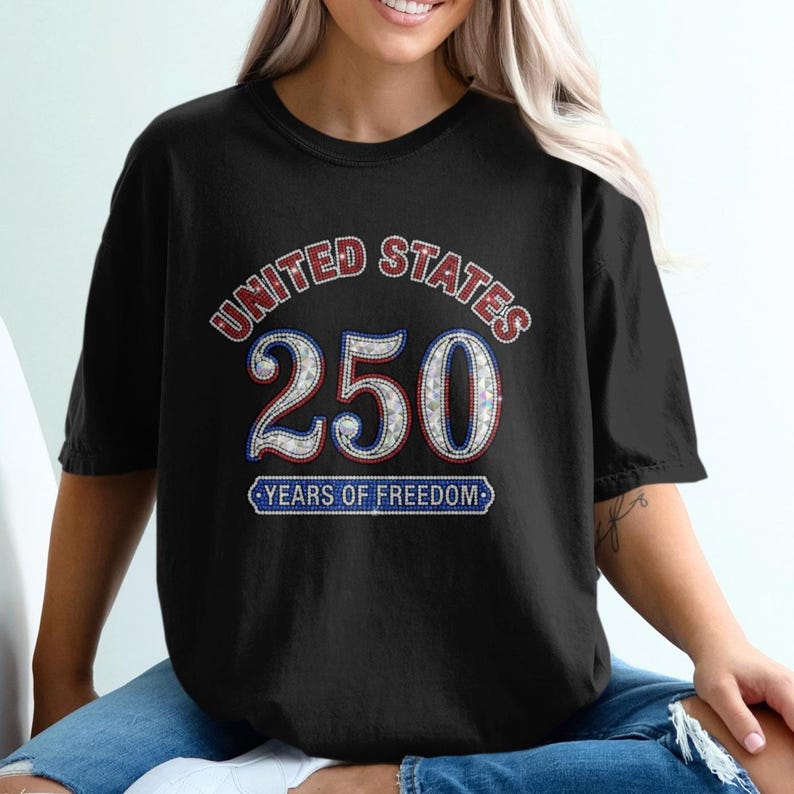 Black t-shirt with "UNITED STATES 250 YEARS OF FREEDOM" text and rhinestones.