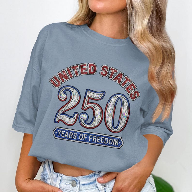 Woman wearing a grey t-shirt with "United States 250 Years of Freedom" text.