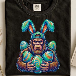 Bigfoot Easter T-Shirt, Comfort Colors Funny Sasquatch Bunny Ears T-Shirt, Colorful Easter Egg Hunt Gorilla T-Shirt,  Spring Holiday Tee
