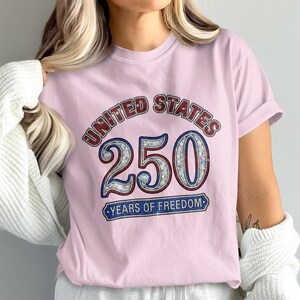 Pink t-shirt with "United States 250 Years of Freedom" text in mosaic style.