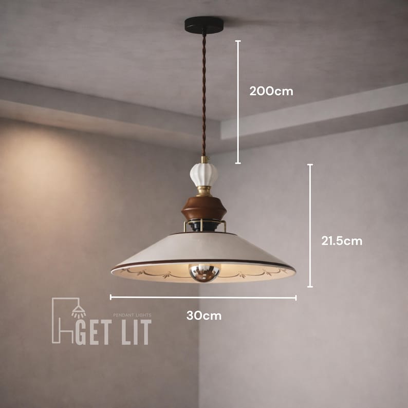 May include: Cream-colored pendant light with a 11.8-inch diameter and a 78.7-inch drop. The light fixture features a brown and white decorative element and a reflective bulb. The text "GET LIT" is visible.