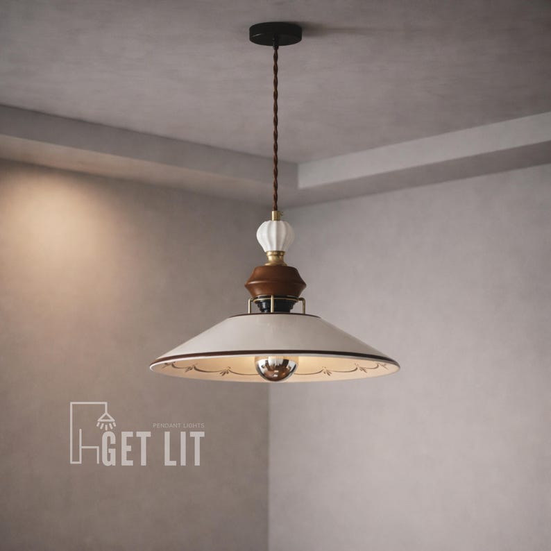 May include: A pendant light fixture with a white lampshade and a decorative brown and white accent. The light has a brown cord and a black ceiling mount. The text "GET LIT" is visible in the lower left corner.