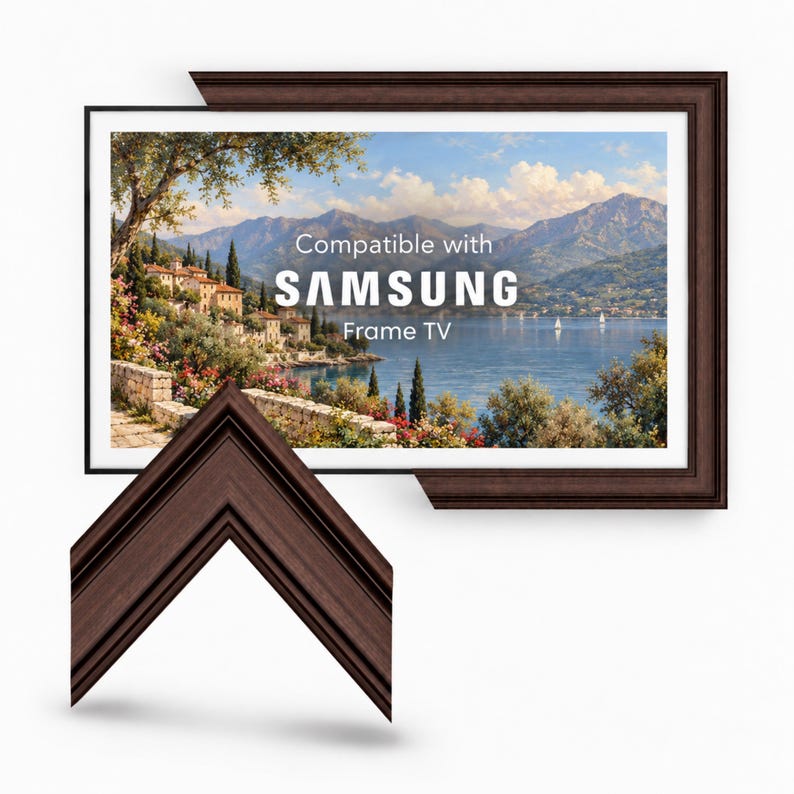 May include: A dark brown wooden television frame with a stepped profile, shown surrounding a landscape painting of a lake and mountains. The screen displays the text Compatible with SAMSUNG Frame TV in white, centered over the scenic view.