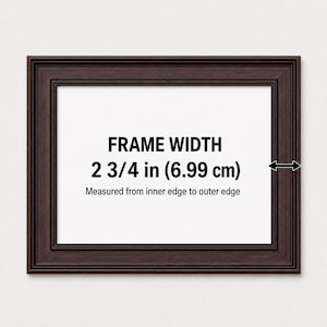 May include: A dark brown rectangular picture frame with a stepped profile. The center displays the text FRAME WIDTH 2 3/4 in (6.99 cm) Measured from inner edge to outer edge, with a black arrow indicating the width of the frame border.