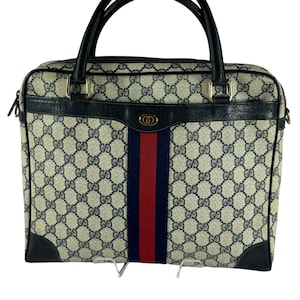 Bolso tipo cartera GUCCI de la colección de accesorios Sherry Line de piel y lona con GG en color azul marino