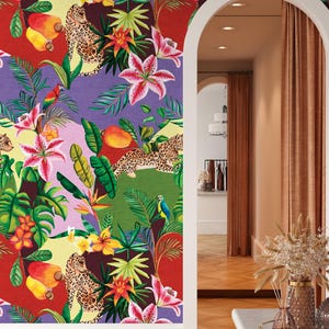 May include: Vibrant wallpaper featuring a jungle theme with leopards, parrots, and tropical flowers. The design includes large pink lilies, mangoes, and lush green foliage against a patchwork of red, purple, and green backgrounds. The wallpaper is installed on a wall with a white trim.