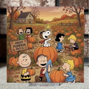 May include: A square print featuring the Peanuts characters in a pumpkin patch with a wooden sign that reads GREAT PUMPKIN PATCH. Snoopy sits on a large orange pumpkin with Woodstock on his head, surrounded by Charlie Brown, Linus, and friends.