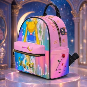 May include: A pink backpack featuring a Sailor Moon graphic with blonde hair, a crescent moon wand, and the text Sailor Moon. The side displays a black cat face, a red rose, and the text moonlight. It has gold zippers and black straps.