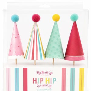 May include: A set of four cone-shaped cake toppers in a clear display box. Each topper features a colorful pom-pom on top and a wooden pick base. The designs include pink with dots, multi-colored stripes, mint green with dots, and solid dark pink.