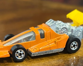 Auto da corsa Hot Wheels Formula del 1979, colore arancione.