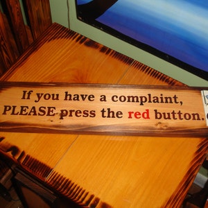 If you have a complaint, PLEASE press the red button. Hand painted sign