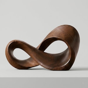 May include: A dark brown wooden sculpture shaped like an infinity symbol. The smooth, curved design is a decorative item. The sculpture is suitable for display on a shelf or table, made from dark brown wood.