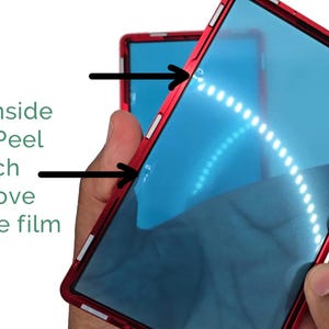 May include: A red phone case with a blue screen protector. The text on the image reads: "On the Inside Gently Peel & Pinch to remove protective film."