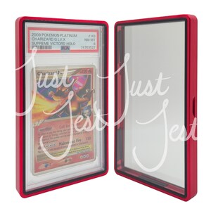 May include: A red protective case for a Pokemon trading card. The card features a Charizard illustration with text that reads "2009 Pokemon Platinum Charizard G LV.X Supreme Victors-Holo". The case is open, revealing the card.