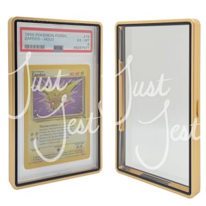 May include: A gold-colored display case with a black border, showcasing a Pok&eacute;mon card. The card features Zapdos, a yellow and purple electric-type Pok&eacute;mon. The case is open in one image, and closed in another.