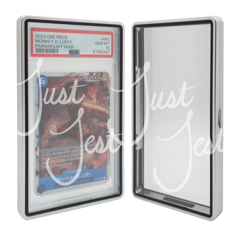 May include: A graded trading card of Monkey D. Luffy from the 2023 One Piece Paramount War series, encased in a protective holder. The card is graded GEM MT 10. The holder is white with a black border, and the card features a colorful illustration.