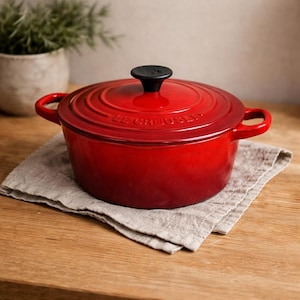 May include: A white ceramic mug with a black handle and the text "But First, Coffee" in a black, handwritten-style font. The mug is on a white surface.