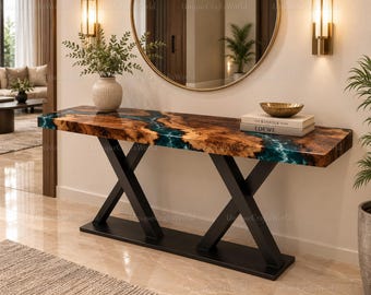 Mesa consola de madera de raíz con borde natural, color verde azulado, con acabado de resina epoxi y efecto oceánico.