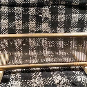 May include: A wooden loom with a metal frame and wooden dowels. The loom is set up for weaving and is ready to be used.