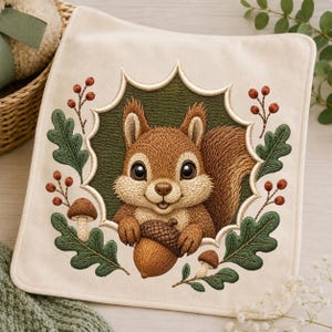 May include: A square cream-colored fabric piece featuring an embroidered design of a brown squirrel holding an acorn. The squirrel is framed by a dark green scalloped border, surrounded by embroidered oak leaves, small mushrooms, and red berries.