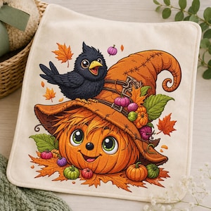 May include: A square off-white fabric cloth featuring a colorful illustration of a smiling orange pumpkin character wearing a large, weathered orange witch hat, topped with a small black bird, surrounded by autumn leaves and tiny pumpkins.