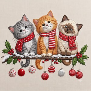 May include: An embroidery design featuring three kittens sitting on a snow-covered branch. A gray kitten, an orange kitten, and a Siamese kitten each wear a red winter scarf. The branch is decorated with green holly leaves, red berries, and hanging ornaments.